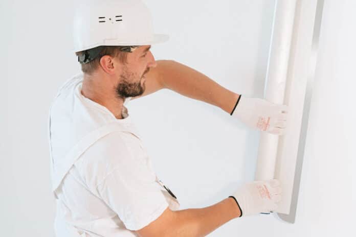 A Man Fixing the Wall
